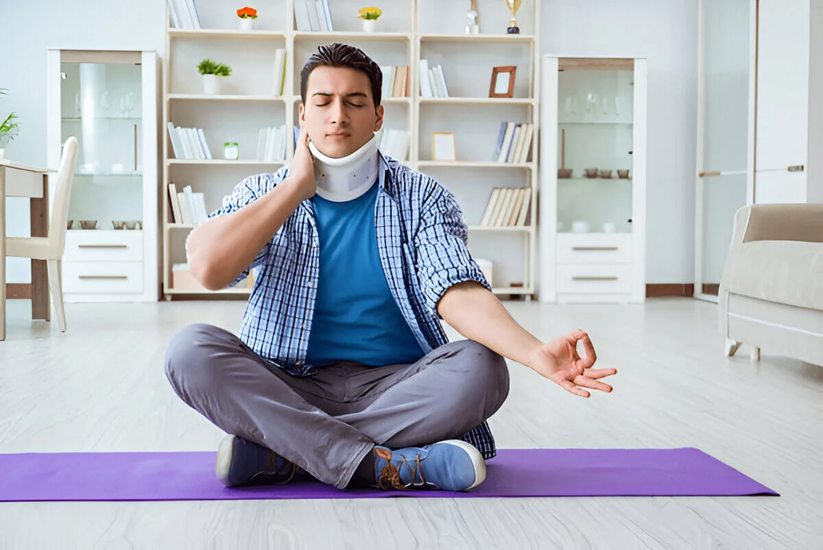 man with whiplash meditating