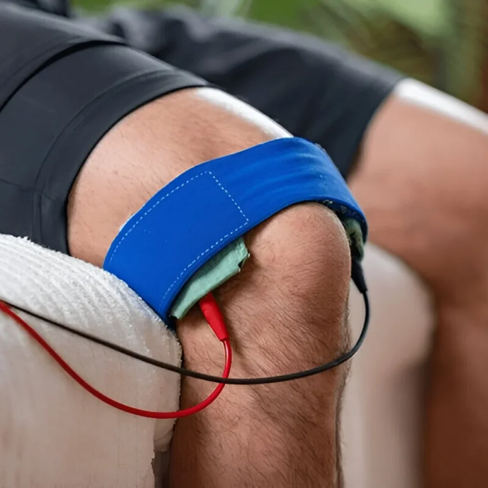 A patient on knee therapy with electrotherapy treatment for pain relief and rehabilitation