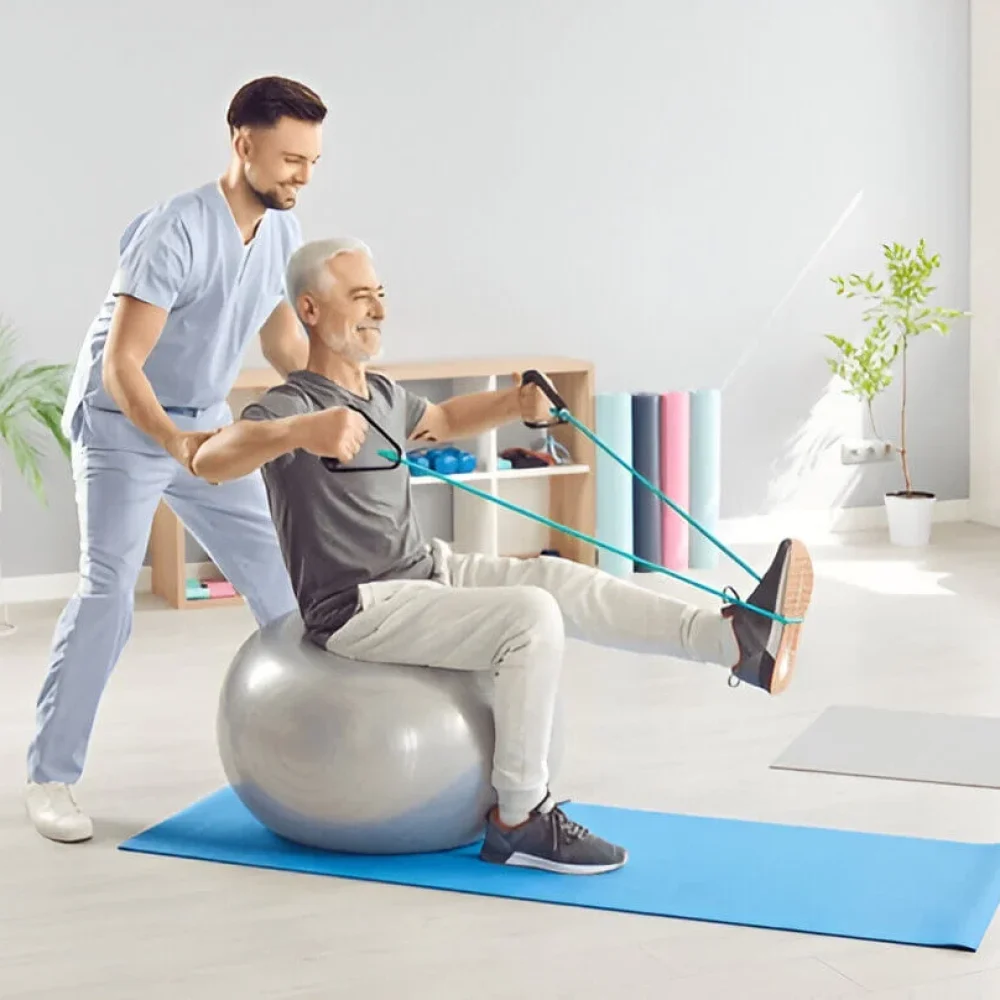 Doctor or nurse involved in the rehabilitation of an elderly patient, conducting physical therapy exercises